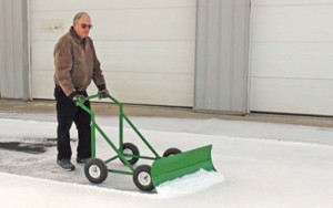 Paul Starner demonstrates an eco-friendly, easy-to-use snow plow that he and his neighbor, Jerry Schichtel, developed and call the “Snow Bully.” Their website is TheSnowBully.com.