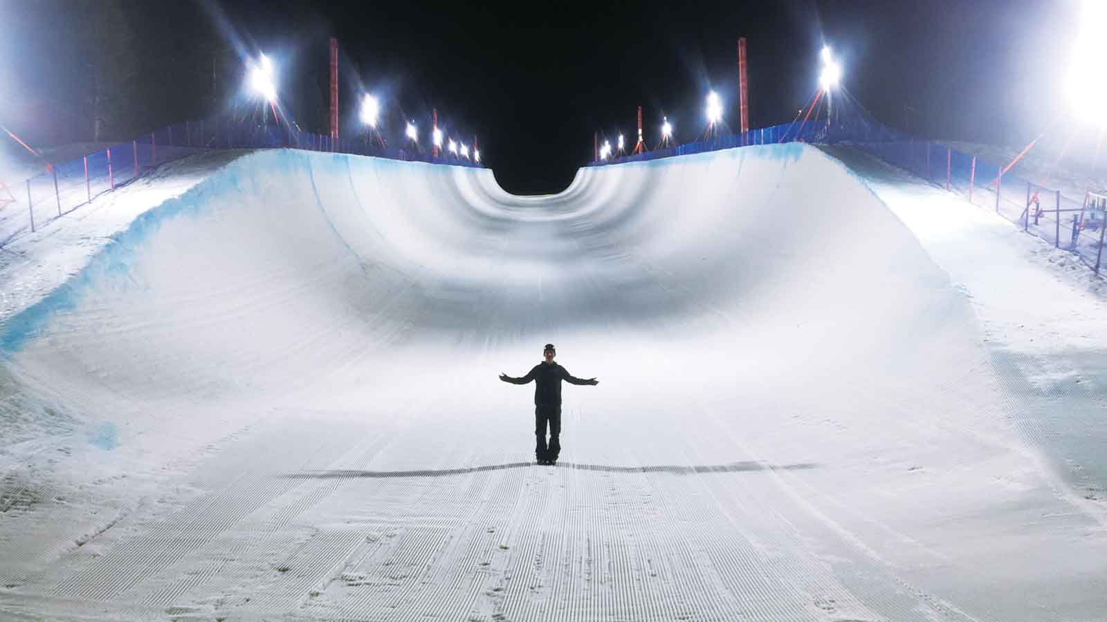 A spectator views the Mammoth Mountain Grand Prix Olympic Qualifier super-pipe all lit up and in its glory.