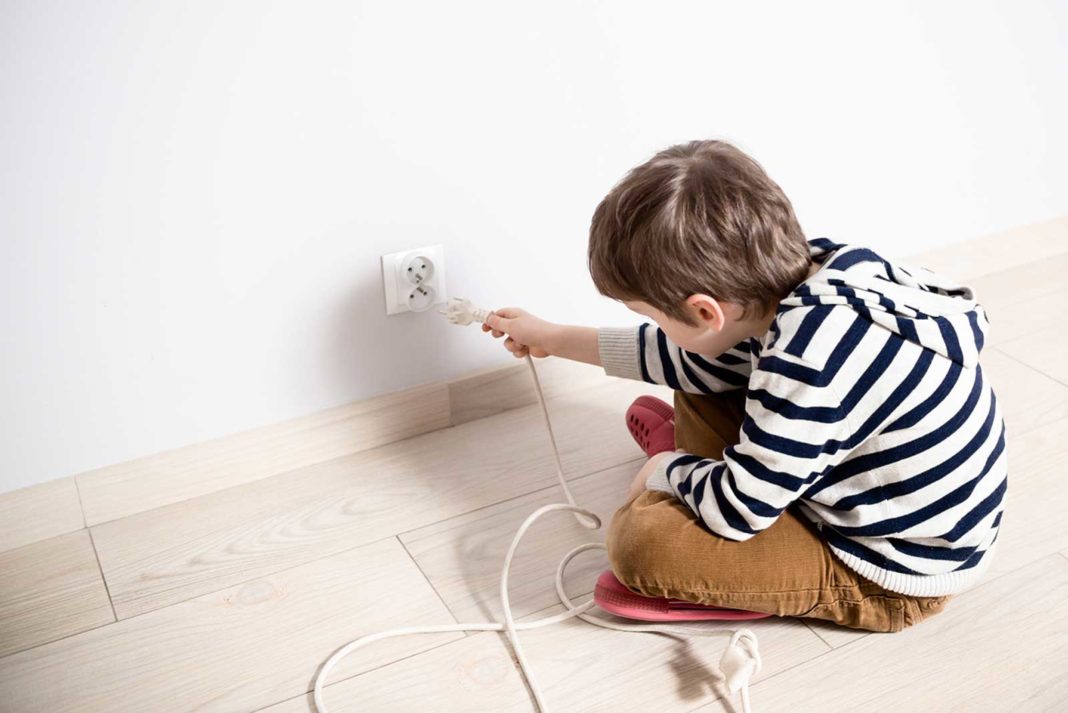 Kid plugging in power cord