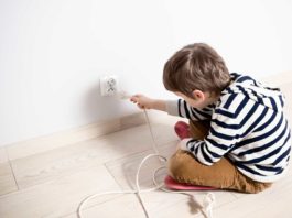 10 Electrical Safety Tips For Kids Kid plugging in power cord
