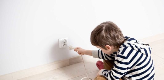10 Electrical Safety Tips For Kids Kid plugging in power cord