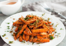 Garden Fresh- Enter by March 1 Baby carrots roasted with parmesan and herbs served with sauce on grey table