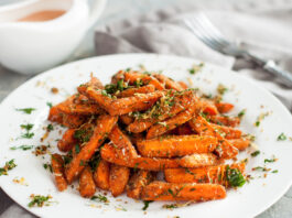 Garden Fresh- Enter by March 1 Baby carrots roasted with parmesan and herbs served with sauce on grey table